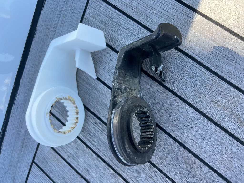 Worn black cam lever and bent bolt above two new silver lever kits with bushings and pins